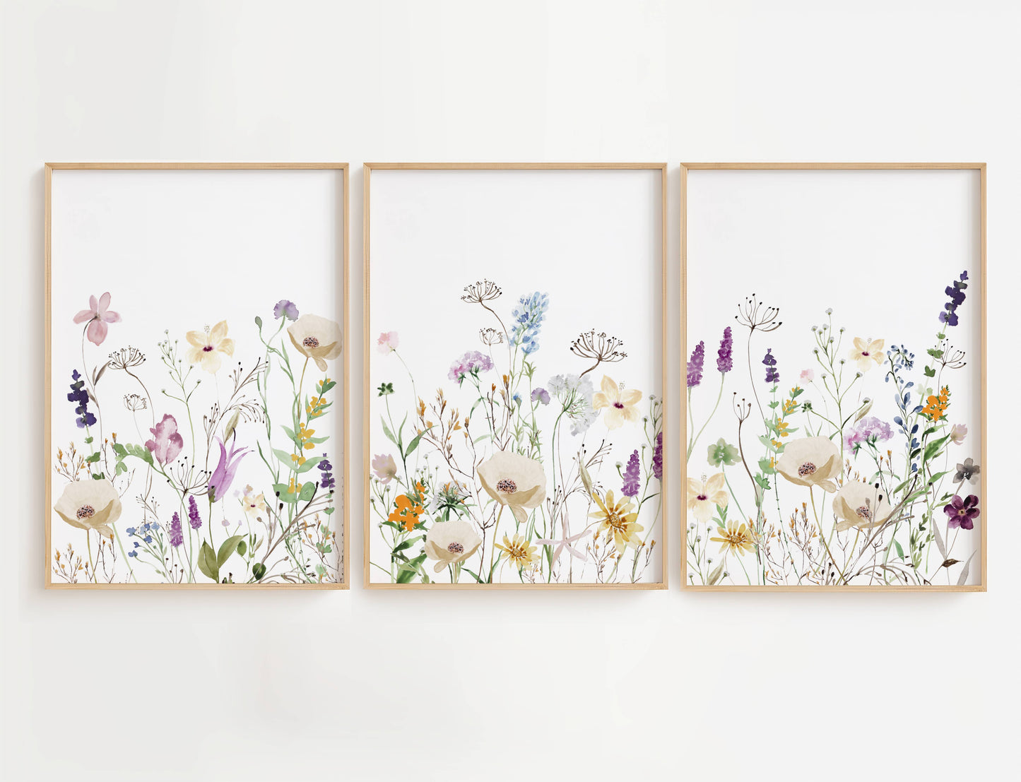 Purple and Orange Wildflowers wall art is a high-quality decor set featuring three beautifully designed prints filled with a mix of purple, orange, and white floral blooms.