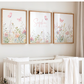 Nursery room with white crib, teddy bear, and floral wall art.
