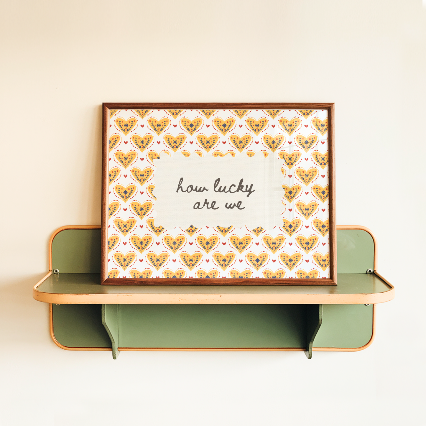 Decorative wall shelf with a framed print featuring heart patterns and text on a beige background