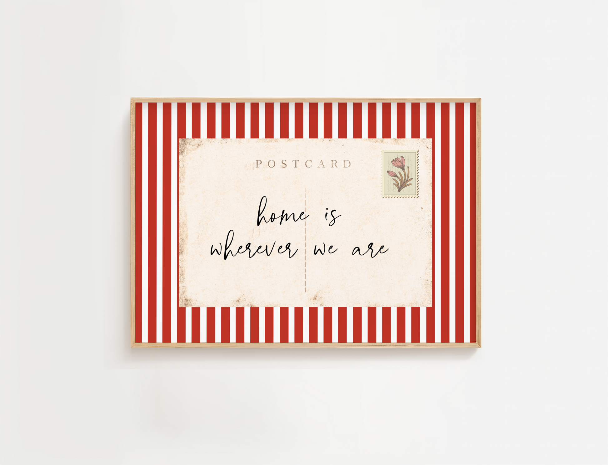 Framed postcard with red and white striped border and 'home is wherever we are' text.