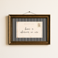 Framed postcard with 'home is wherever we are' text on a striped background