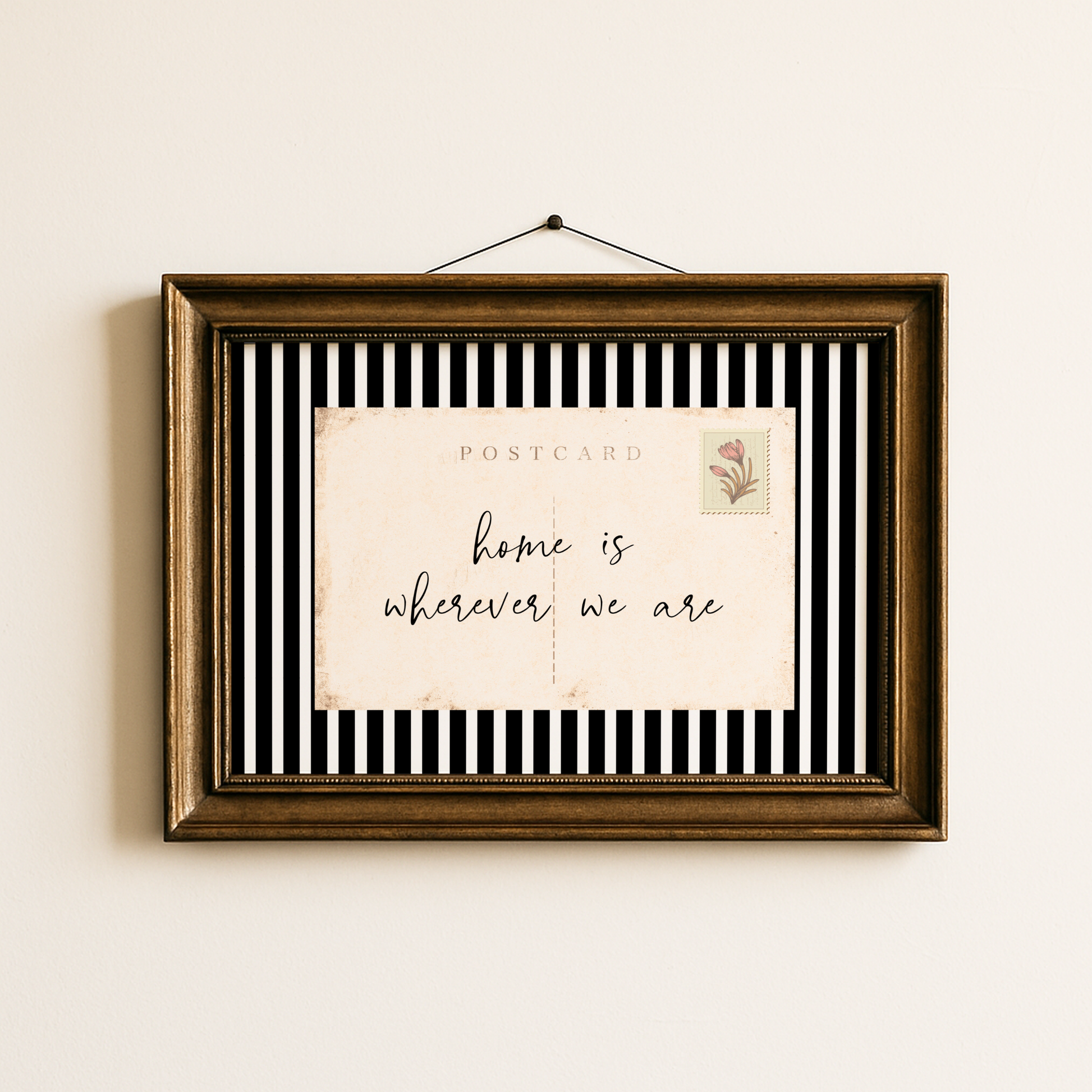 Framed postcard with 'home is wherever we are' text on a striped background