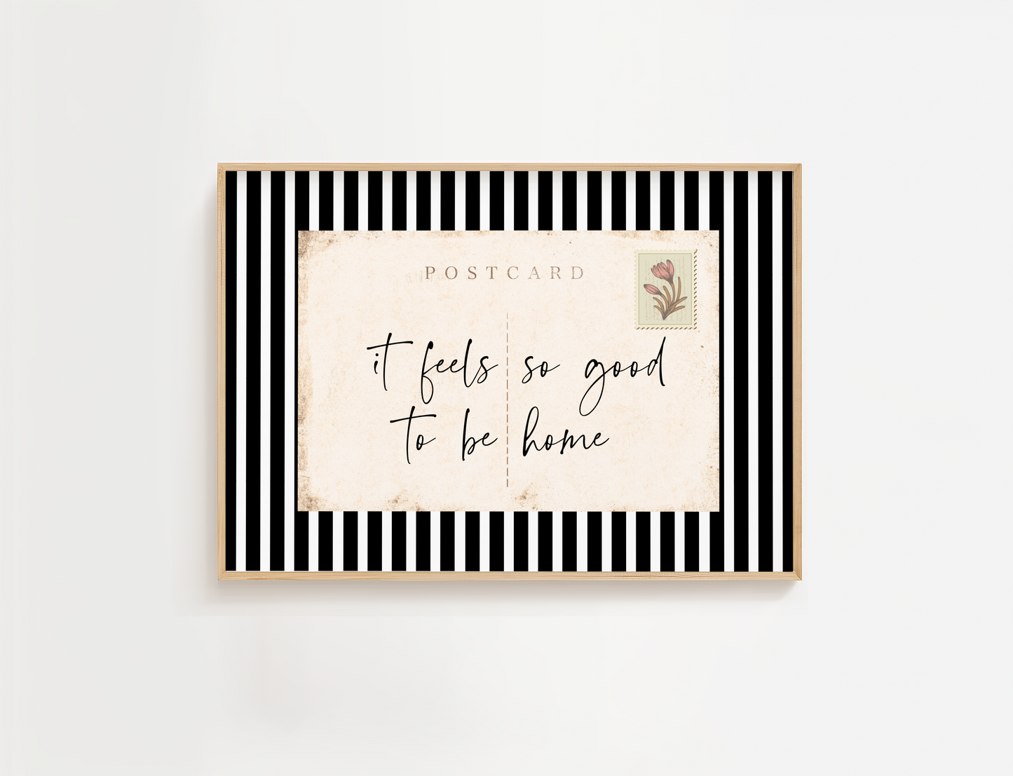 Framed postcard with 'it feels so good to be home' text on a white background