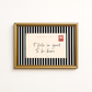 Framed postcard with 'it feels so good to be home' text on a striped background