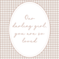 Decorative card with 'Our darling girl, you are so loved' text on a checkered background
