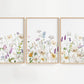 Purple and Orange Wildflowers wall art is a high-quality decor set featuring three beautifully designed prints filled with a mix of purple, orange, and white floral blooms.
