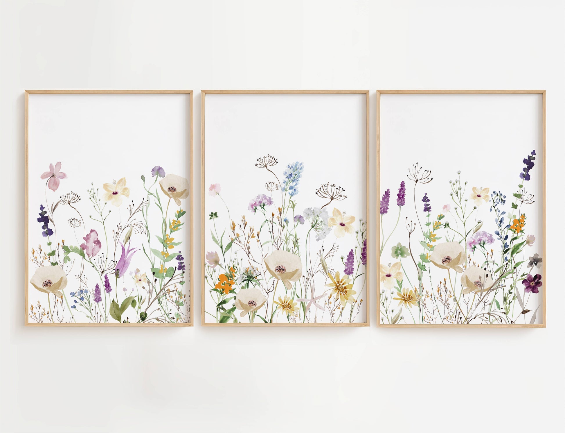 Purple and Orange Wildflowers wall art is a high-quality decor set featuring three beautifully designed prints filled with a mix of purple, orange, and white floral blooms.