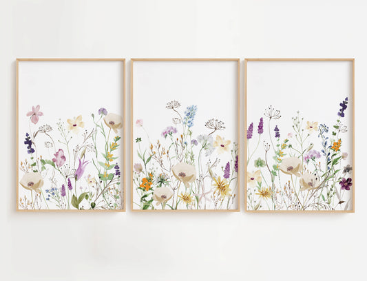 Purple and Orange Wildflowers wall art is a high-quality decor set featuring three beautifully designed prints filled with a mix of purple, orange, and white floral blooms.
