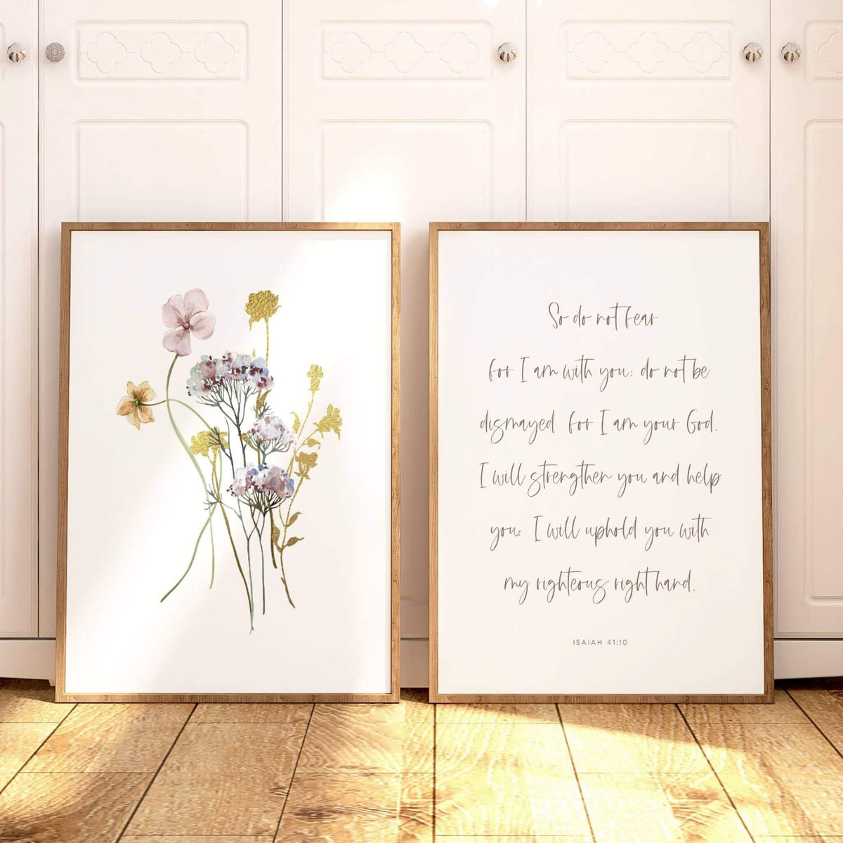 Isaiah 41:10 wall art with wildflowers in wooden frames set against a closet door in a bedroom.