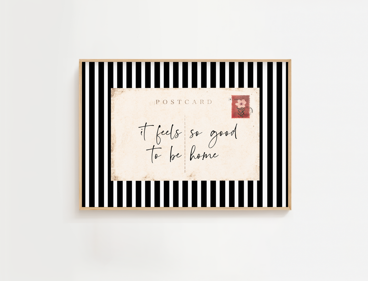 Entry way wall art featuring black and white stripes and a quote, It Feels so good to be home. Entry way welcome sign.