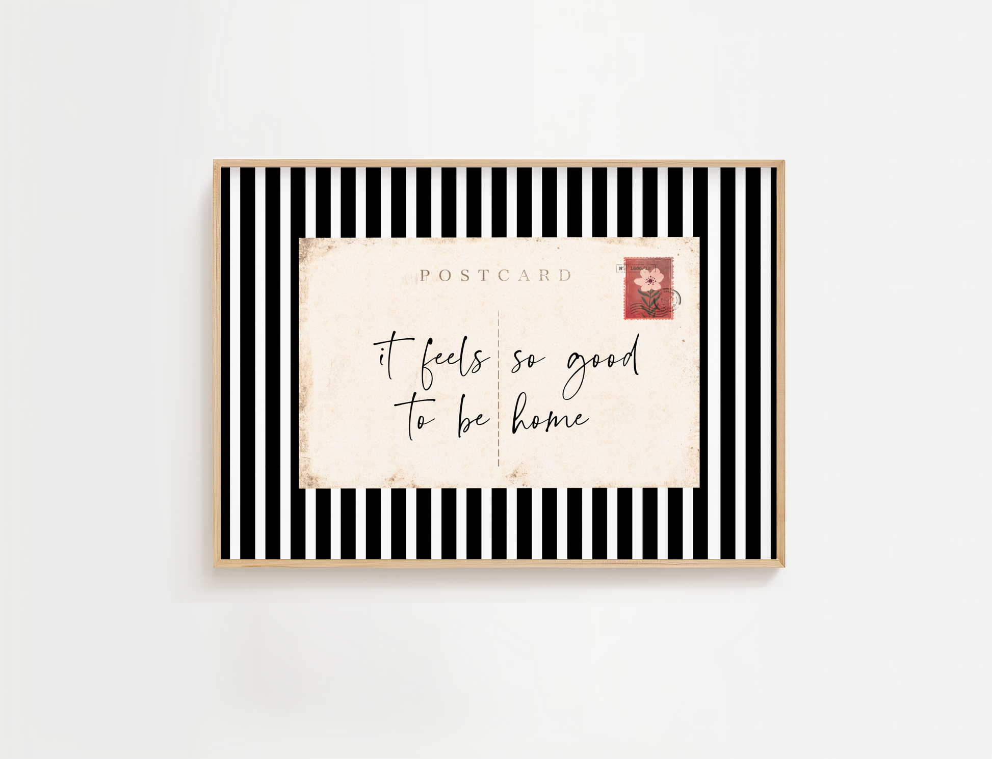 Entry way wall art featuring black and white stripes and a quote, It Feels so good to be home. Entry way welcome sign.