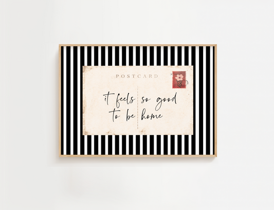 Entry way wall art featuring black and white stripes and a quote, It Feels so good to be home. Entry way welcome sign.