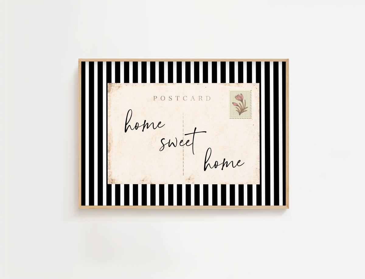 Entry way wall art featuring black and white stripes and a quote, Home Sweet Home. Entry way welcome sign.
