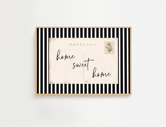 Entry way wall art featuring black and white stripes and a quote, Home Sweet Home. Entry way welcome sign.