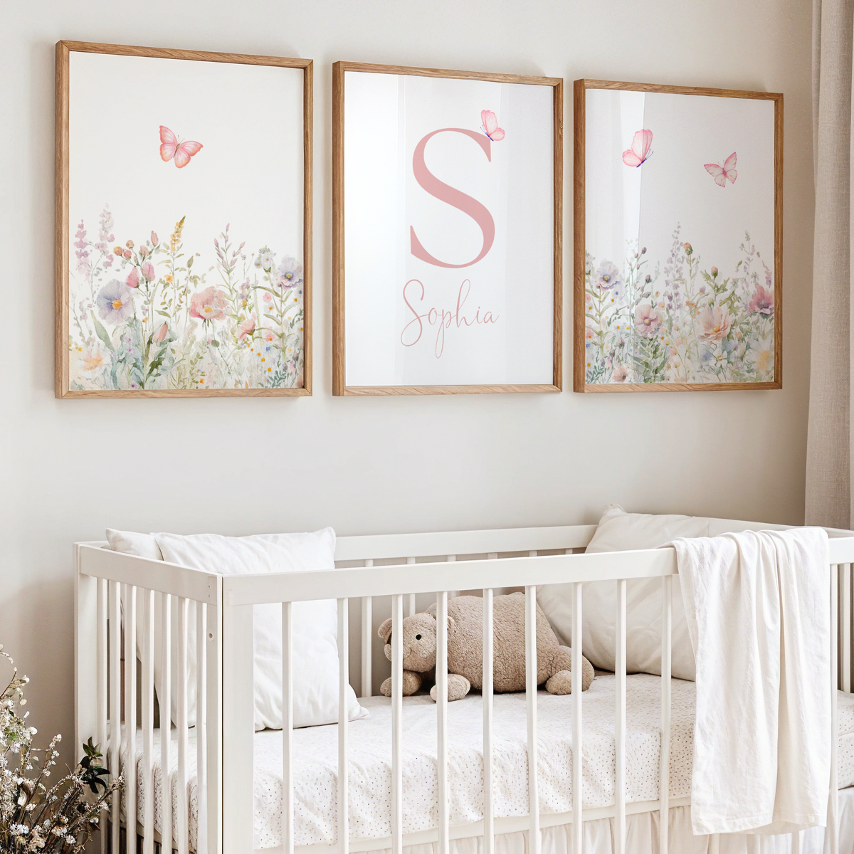 Floral nursery wall art with butterflies featuring a set of 3 prints with sage and pink flowers and a name sign for girl nursery decor.