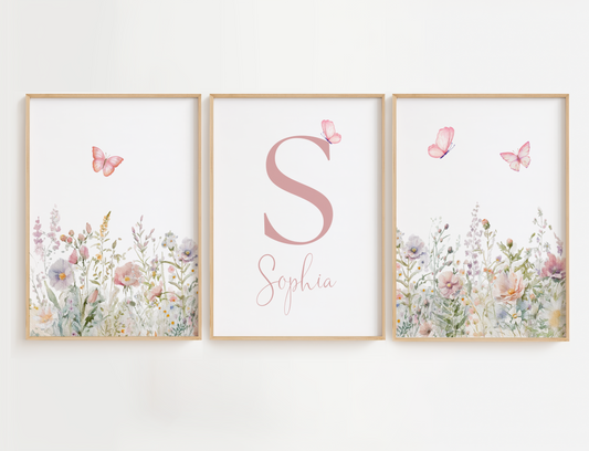 Floral nursery wall art with butterflies featuring a set of 3 prints with sage and pink flowers and a name sign for girl nursery decor.