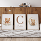 Nursery room with wooden cabinet, teddy bear-themed wall art, and decorative items.