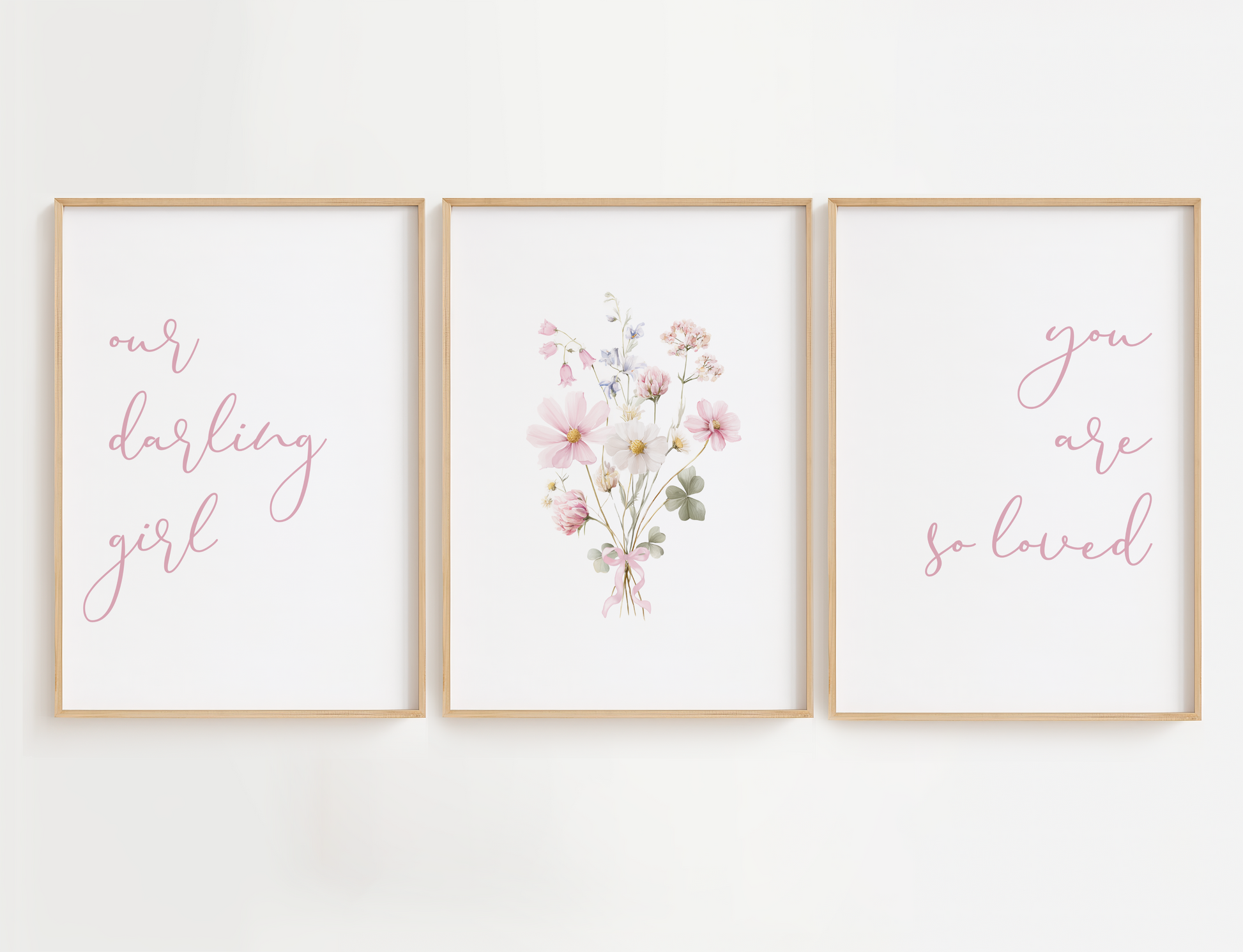 Three framed prints with floral and text design on a white wall.