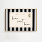 Framed postcard with 'home sweet home' text on a white background