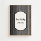 Framed black and white striped print with 'how lucky are we' text on a white background