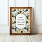 Framed artwork with decorative birds and flowers and text 'What’s the best that could happen?' on a wooden floor.