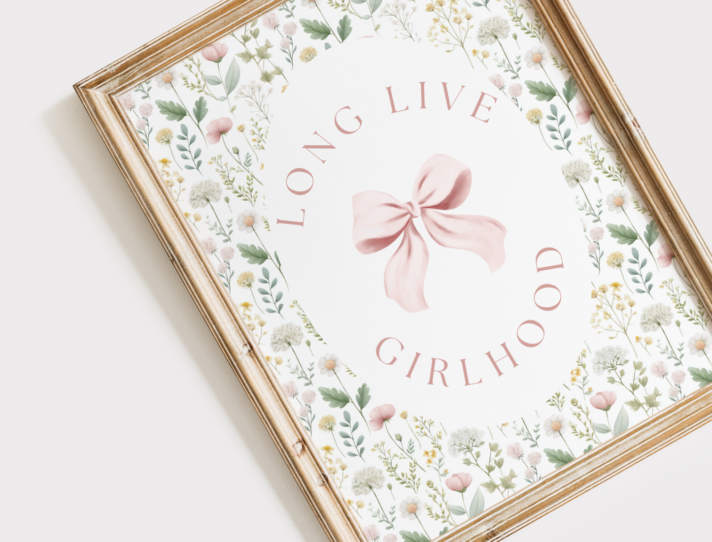 Framed artwork with floral design and 'LIVE LOVE GIRLHOOD' text on a white background