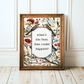 Framed artwork with floral and bird design on a white wall.
