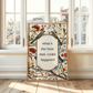 Decorative wall art with floral and bird design in a room with large windows.