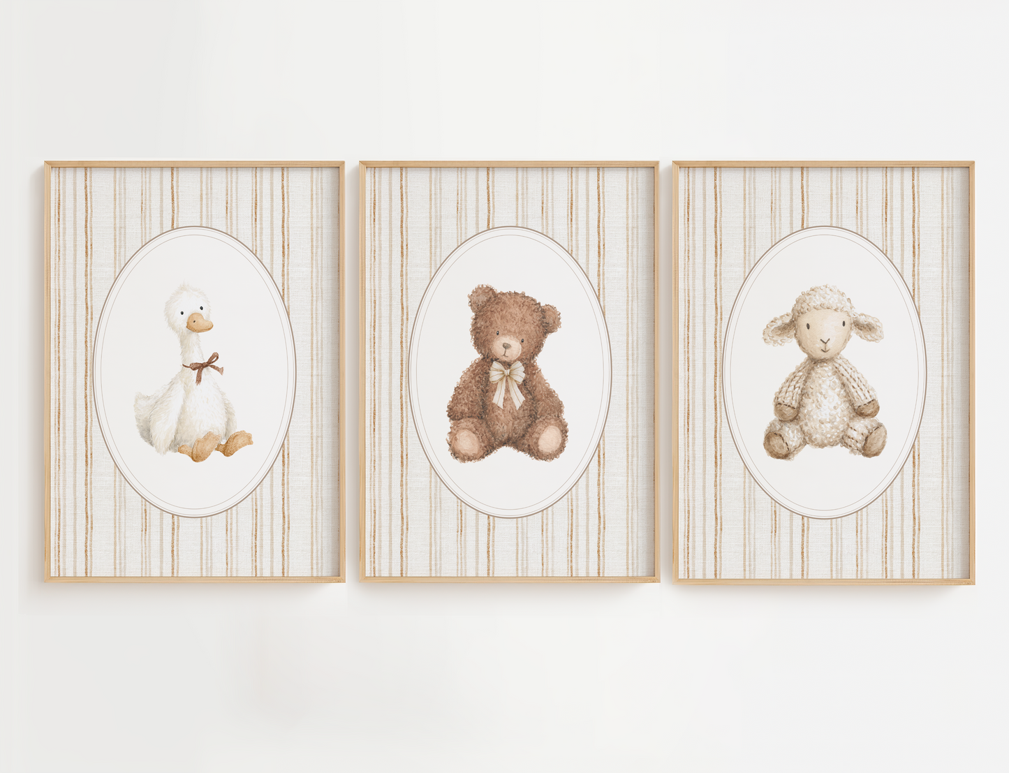 Three framed illustrations of a duck, bear, and sheep on a white wall.