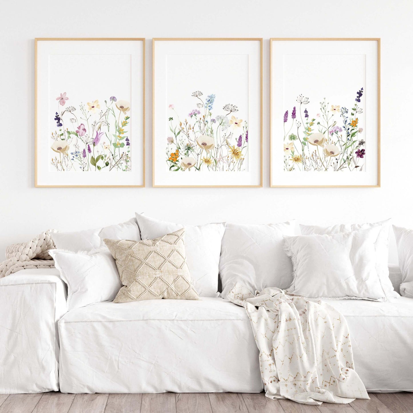 colorful wildflower wall decor set of 3 hanging in living room above a white couch