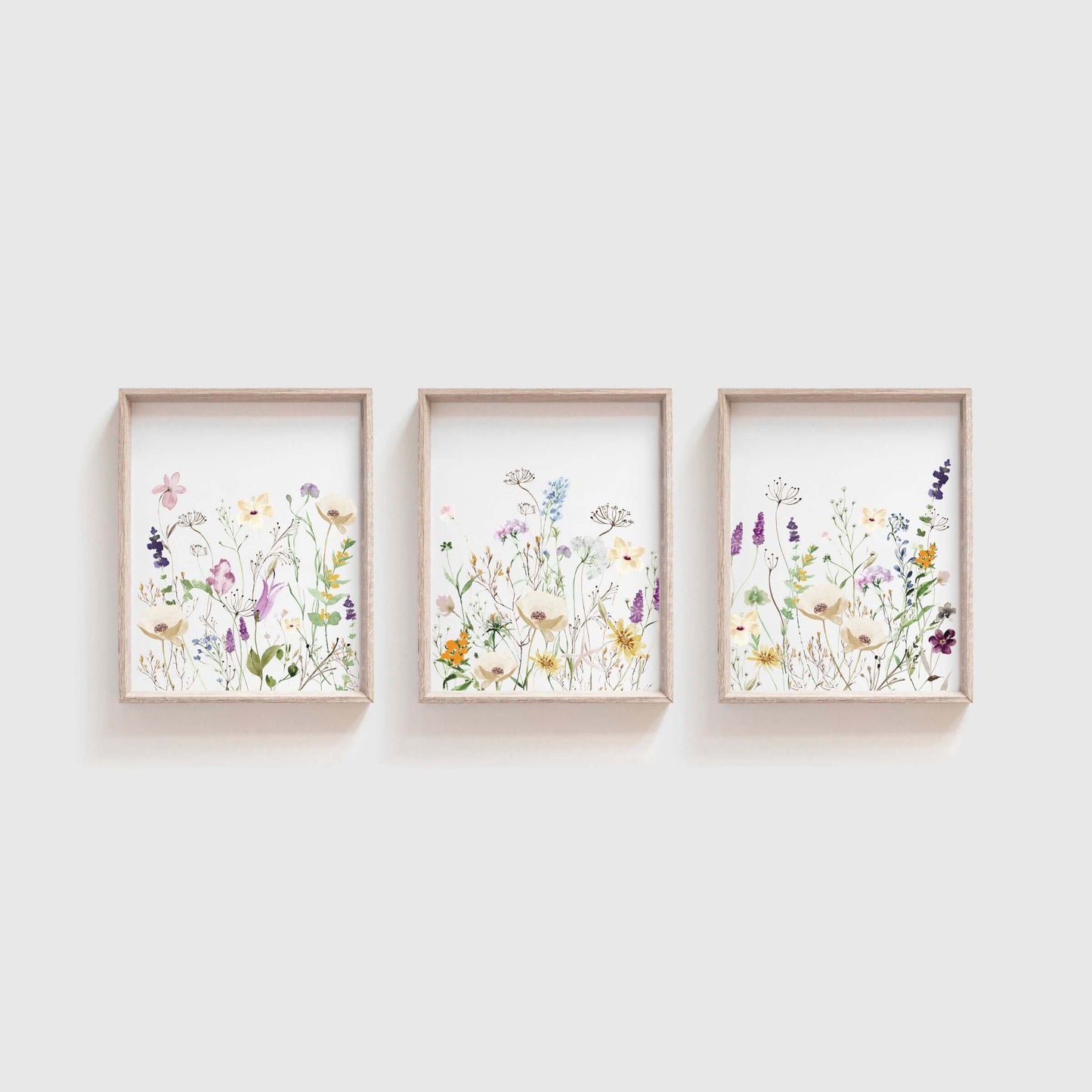 colorful wildflower wall decor set of 3 hanging in living room above a white couch
