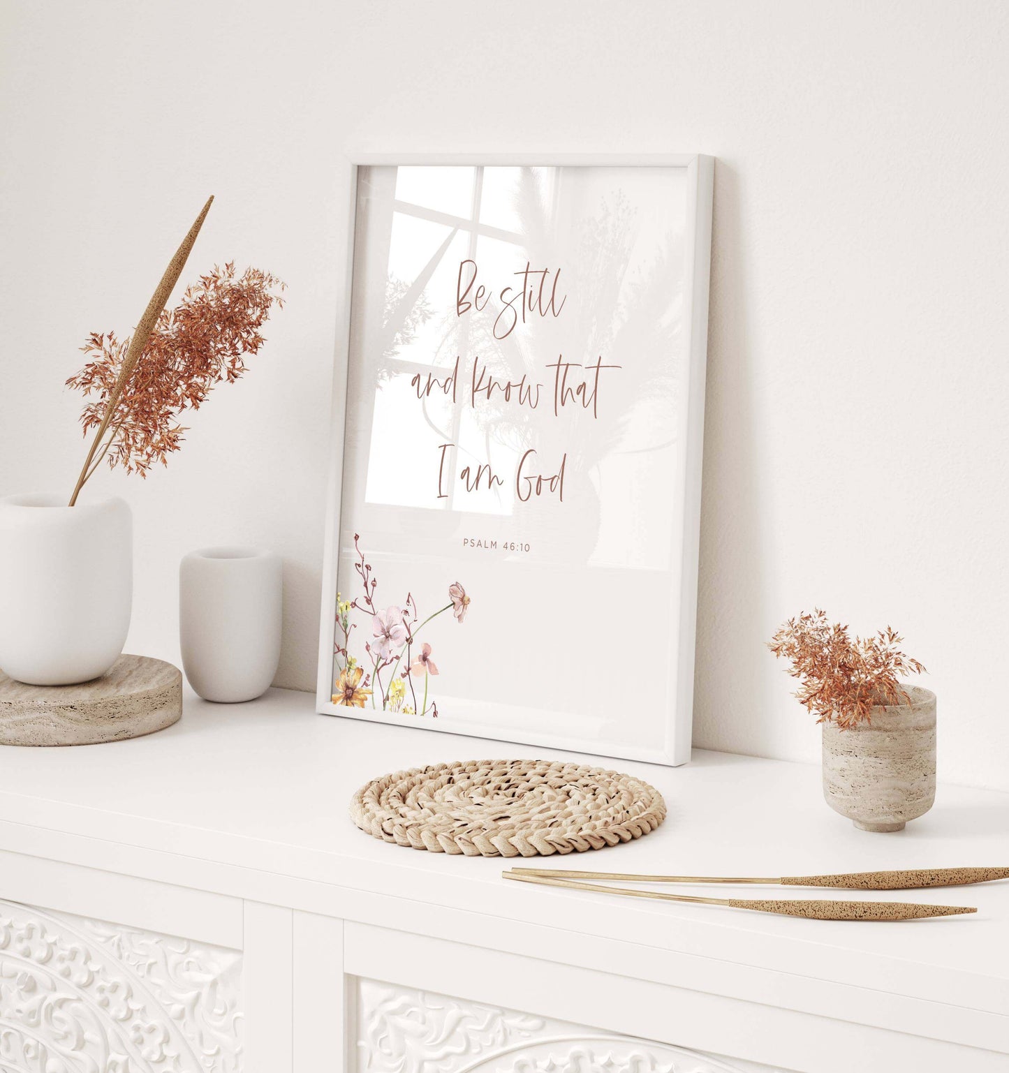 Psalm 46:10 wall art with wildflowers on a desk