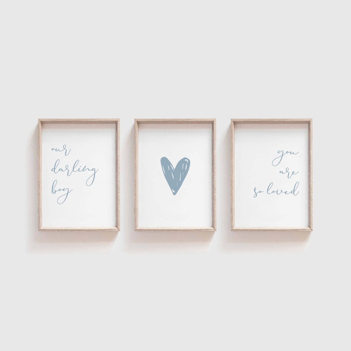 Our darling boy you are so loved nursery wall art set of 3 hanging above a bassinet.